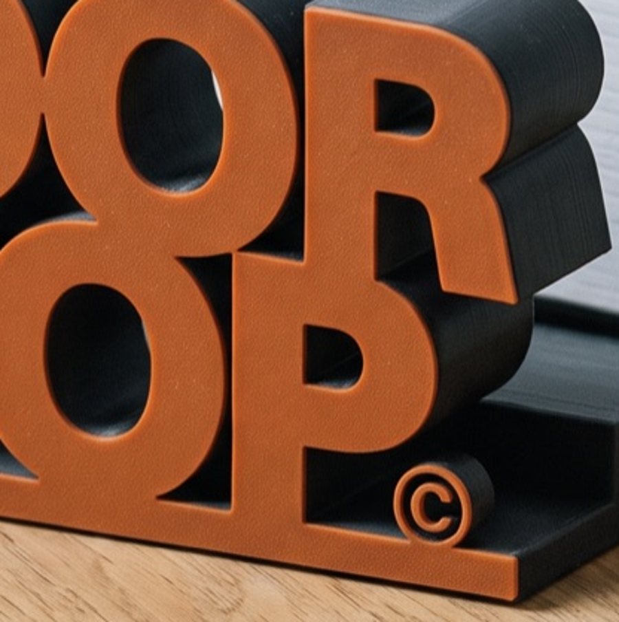 Close up of the letters O, P and the copyright sign standing on the base of the door stop