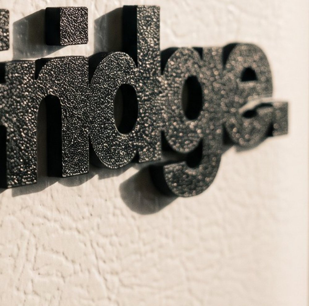 Close up of the r, i and d, the square dot of the i standing off the door
