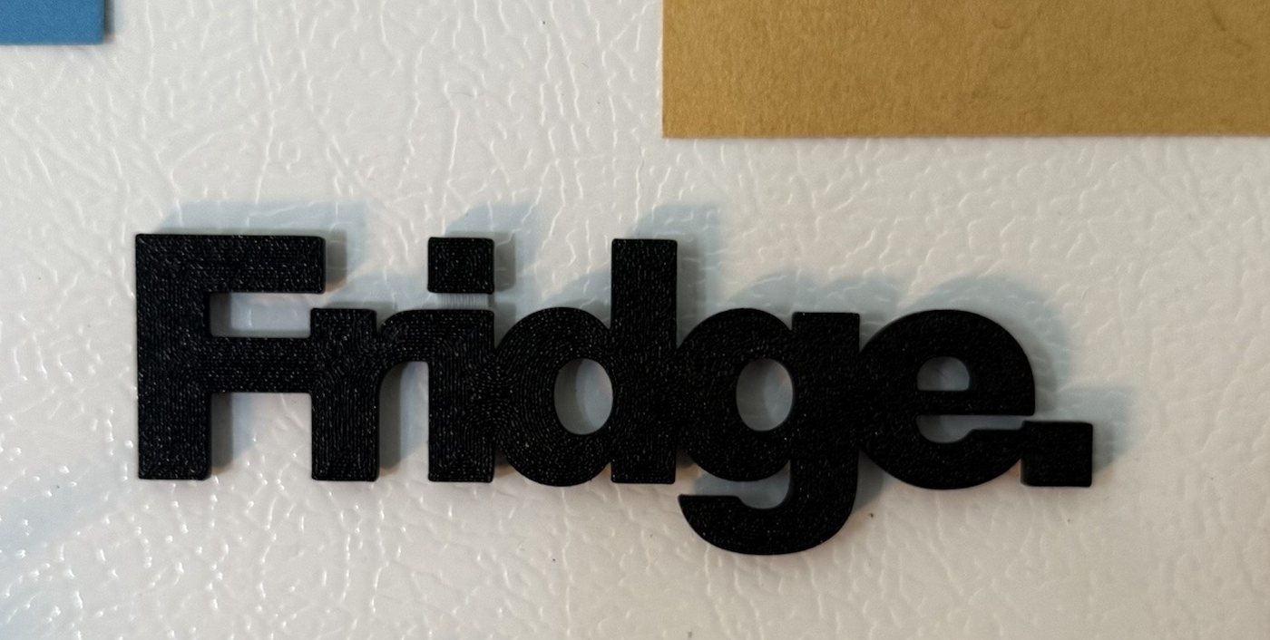 Fridge. on a white fridge between postcards, casting a soft shadow